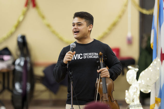 Civic violinist Ebedit Fonseca speaking to concert attendees at the Southwest Regional Senior Center during the 2025 Bach Marathon