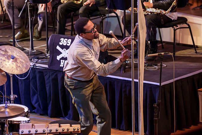 Closeup of Nasheet Waits playing a percussion instrument