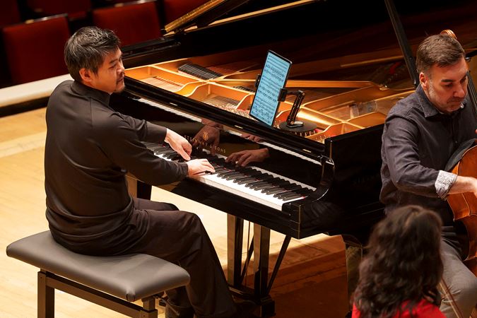Closeup of pianist Winston Choi performing on stage