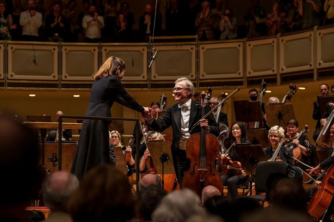 Principal cellist shaking hands with conductor