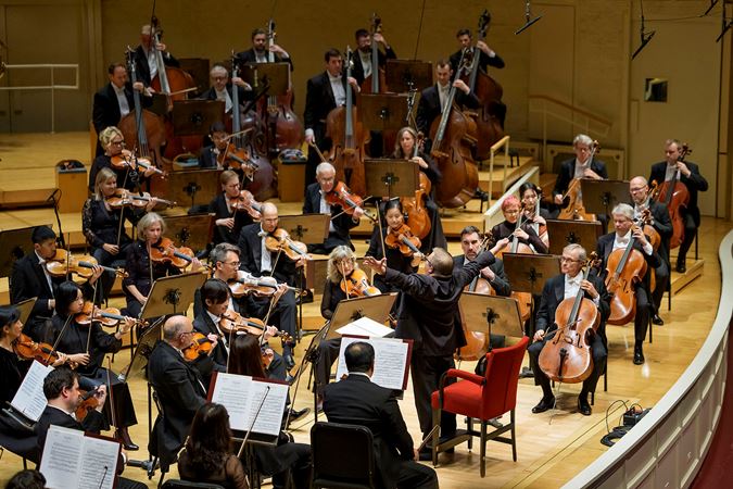 Wide shot of Mikko Franck leading the Chicago Symphony Orchestra on stage