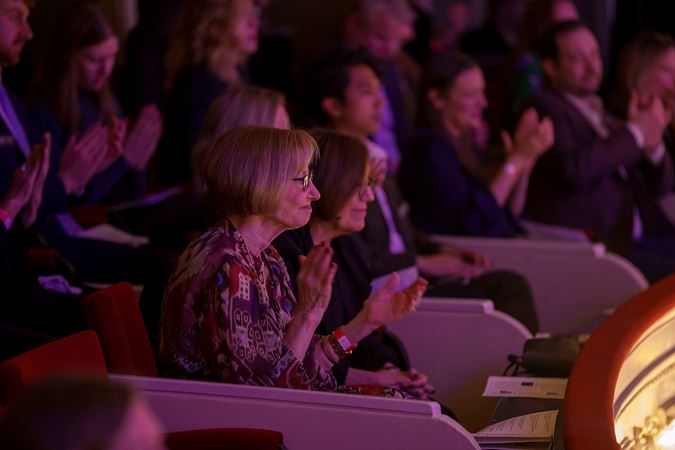 Audience members clapping from a Box