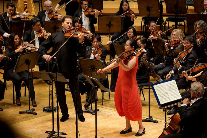 guest violinist Nikolaj Szeps-Znaider, left, and principal viola Teng Li, right, solo together in front of the orchestra
