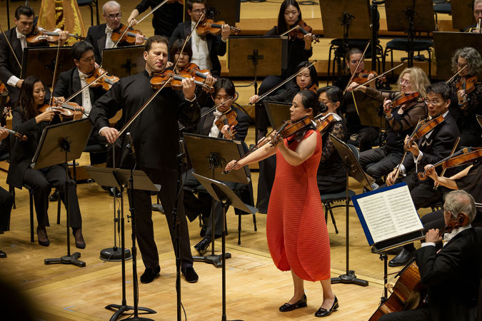 guest violinist Nikolaj Szeps-Znaider, left, and principal viola Teng Li, right, solo together in front of the orchestra