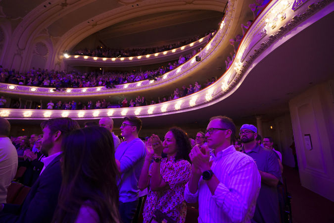 Wide shot of audience members applauding in Orchestra Hall