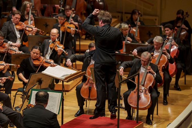 Jakub Hrůša catches air during an animated jump on the podium