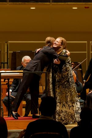 Jennifer Johnson Cano and Daniela Candillari smile and embrace