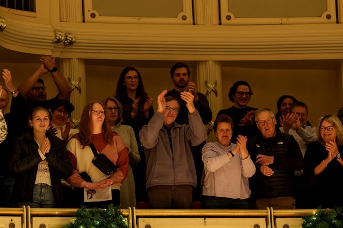 audience members in the terrace give a standing ovation