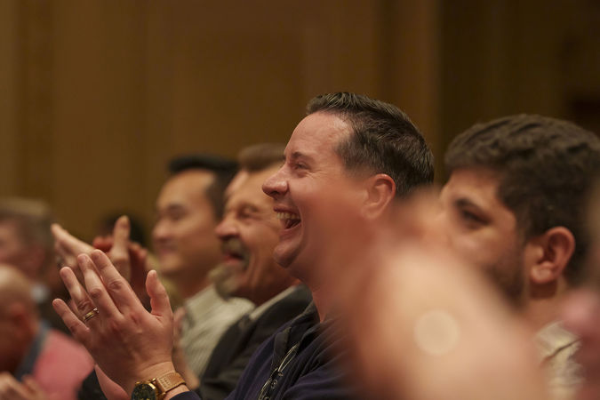 an enthusiastic audience member gives a standing ovation and an open-mouthed smile after Trpčeski's performance
