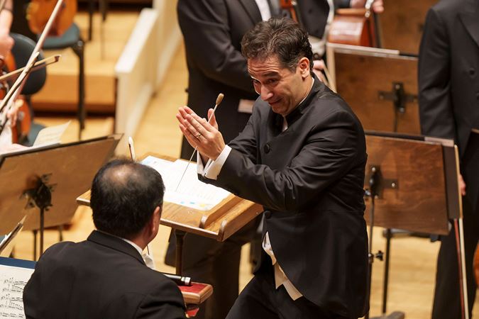 conductor acknowledging orchestra