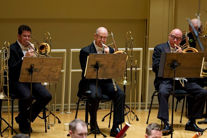 Group shots of the CSO trombone section performing on stage