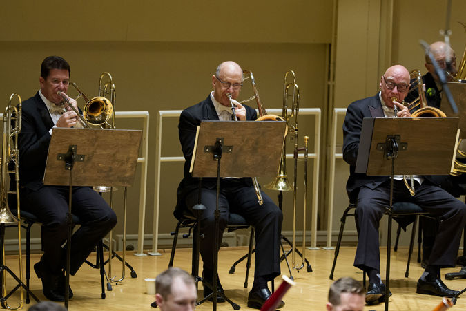Group shots of the CSO trombone section performing on stage