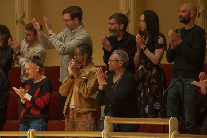 audience members in the terrace rise for a standing ovation