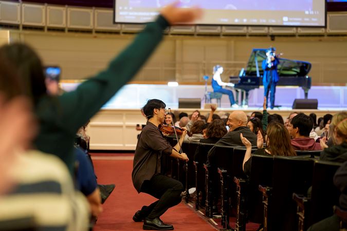 Eddy Chen plays to an audience member in the aisle