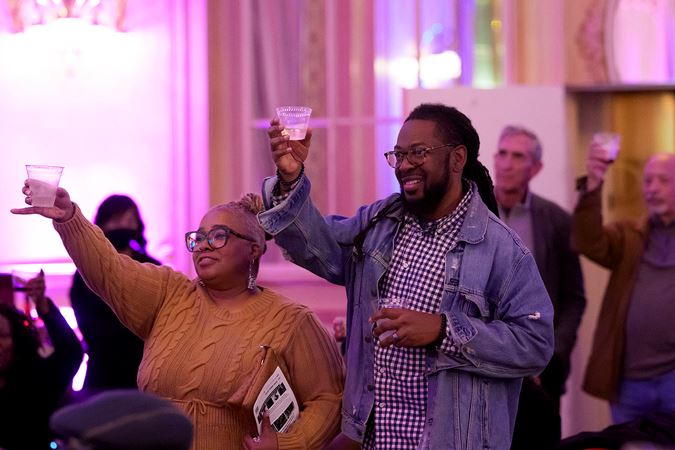 members of the CSO African American Network raise their glasses in a toast at the afterparty in Grainger Ballroom