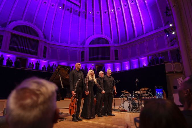 Eliane Elias and her quartet smile, join hands and prepare to take a bow as the audience rises to its feet