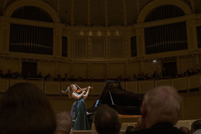Action shot of violinist Julia Fischer performing on stage