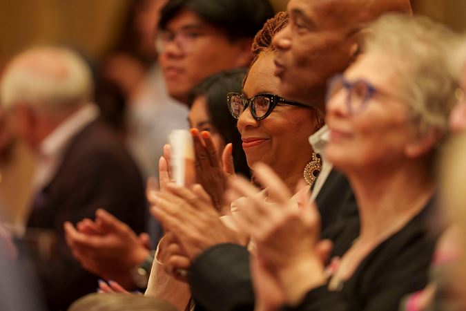 Audience members applauding