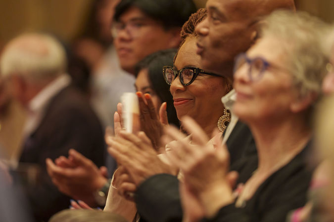 Audience members applauding