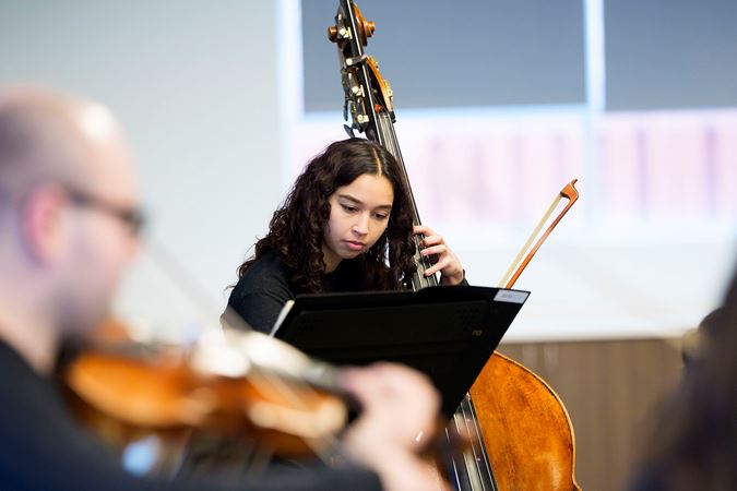 Closeup of Civic bass Gisel Dominguez performing at UCAN during the 2025 Civic Bach Marathon