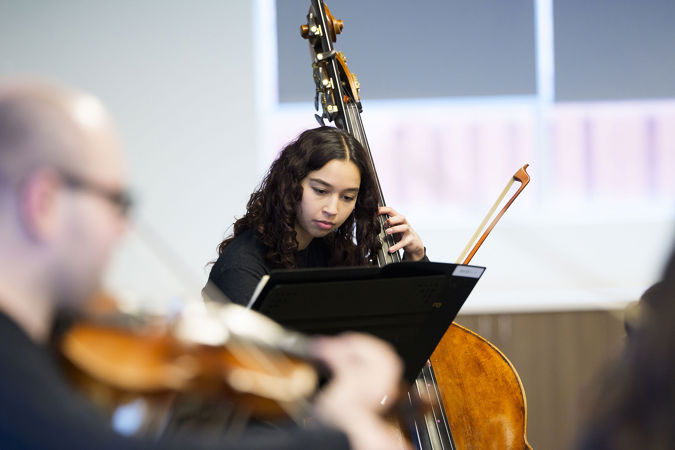 Closeup of Civic bass Gisel Dominguez performing at UCAN during the 2025 Civic Bach Marathon