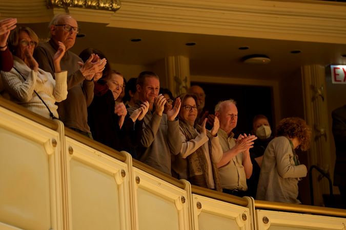 audience members in the terrace applaud