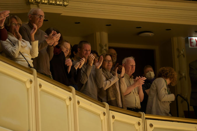 audience members in the terrace applaud