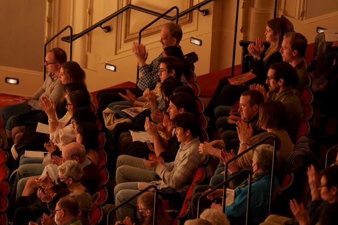 Audience members applauding on the Lower Balcony