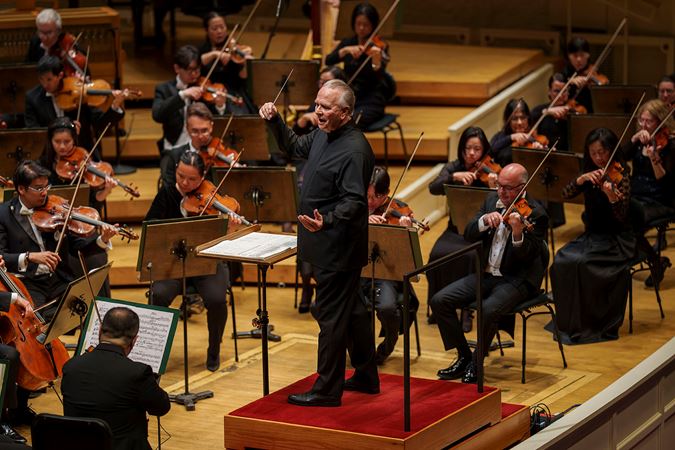 Closeup action shot of Sir Mark Elder leading the CSO