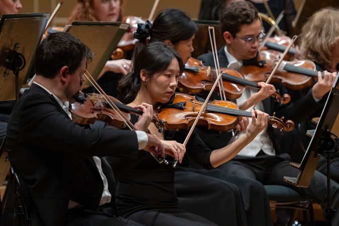 the violin section performing