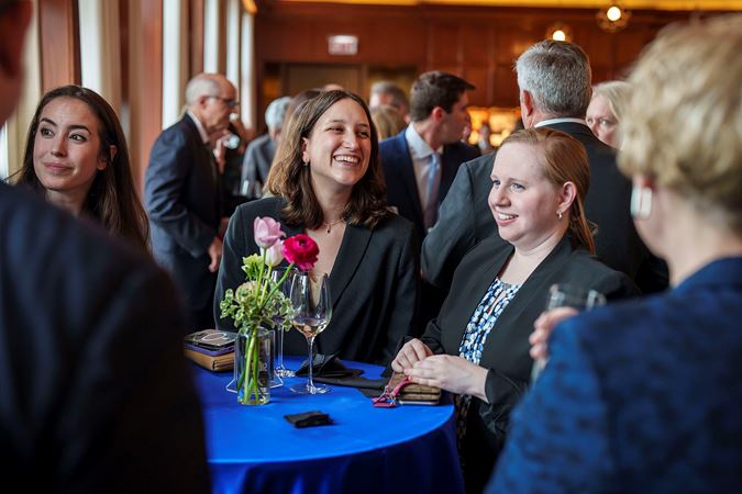A few attendees chatting in Club 9 during a Corporate Night reception