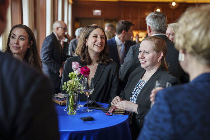 A few attendees chatting in Club 9 during a Corporate Night reception