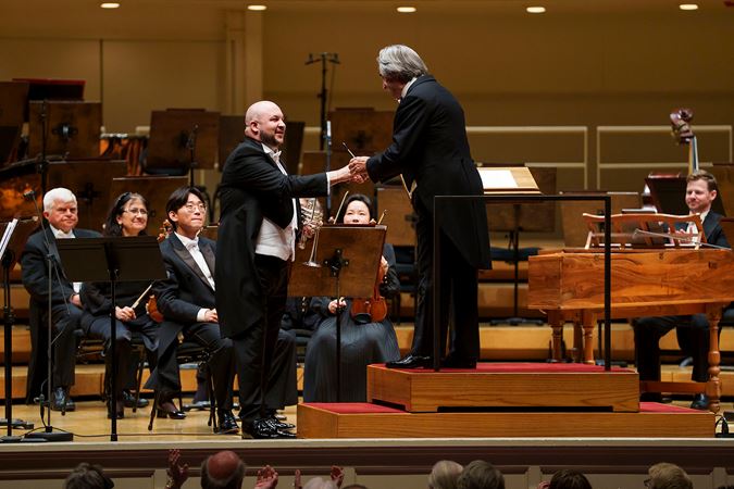 CSO principal trumpet Esteban Batallán shakes hands with Riccardo Muti on stage after his CSO debut