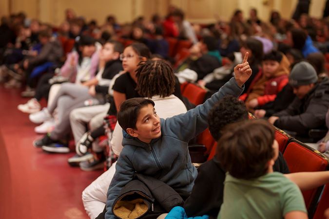 Students looking up at the balcony and gallery in Orchestra Hall from the first row of the main floor