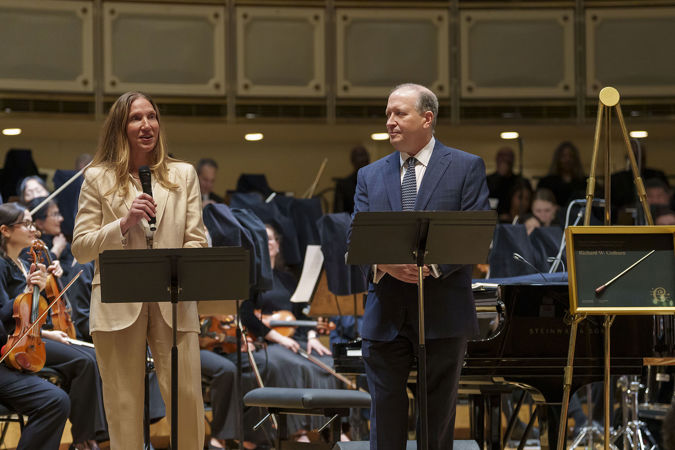 CSOA president Jeff Alexander and Melissa Root present Richard Colburn with the Excellence in Philanthropy Award on stage before the concert