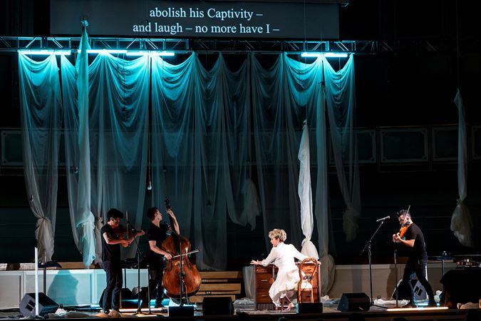 Joyce DiDonato and Time For Three perform Emily - No Prisoner Be, surrounded by white curtains and eerie blue light