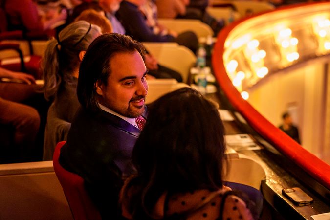 audience members in the box level prepare for the show