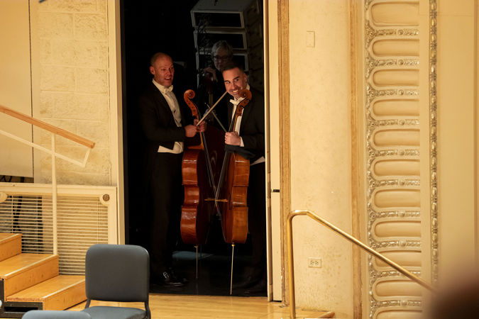 CSO cellos Brant Taylor and Kenneth Olsen standing at a side stage door