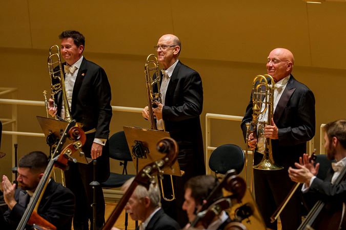 The trombone section, including newly appointed principal trombone Timothy Higgins, takes a collective bow