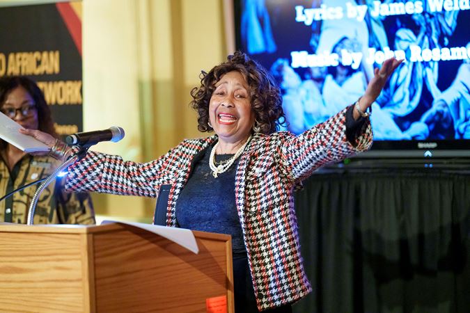 AAN member Joyce Carter leads a singalong of Lift Every Voice