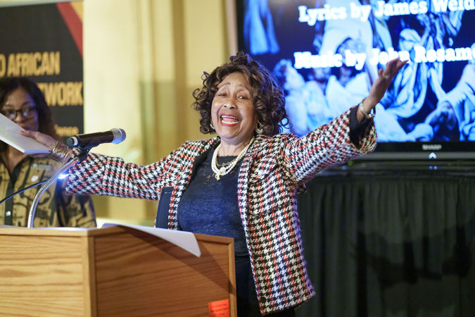 AAN member Joyce Carter leads a singalong of Lift Every Voice
