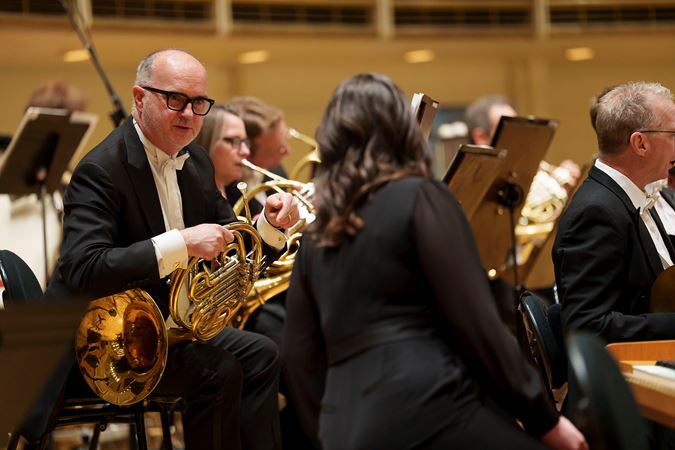 CSO horn David Griffin speaks with CSO associate concertmaster Stephanie Jeong on stage before the performance