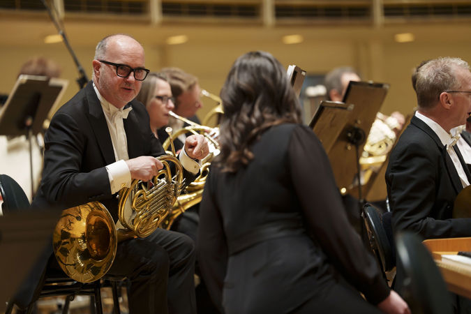 CSO horn David Griffin speaks with CSO associate concertmaster Stephanie Jeong on stage before the performance