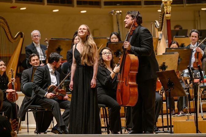 composer Gabriella Smith and cellist Gabriel Cabezas smile and acknowledge the applauding audience after the performance