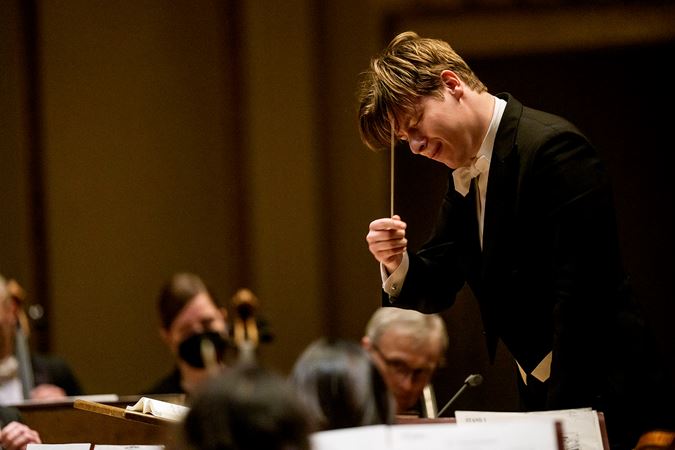 Klaus Mäkelä bows his head, eyes closed and baton raised, basking in an emotional passage of the music