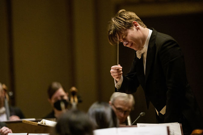 Klaus Mäkelä bows his head, eyes closed and baton raised, basking in an emotional passage of the music