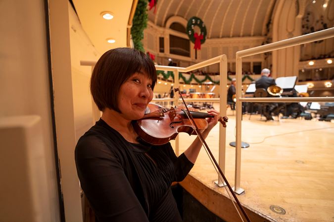 CSO violinist Kozue Funakoshi warms up backstage