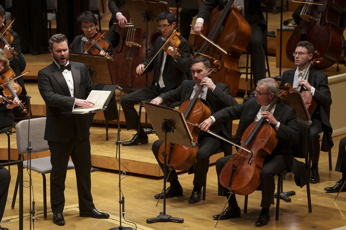 Close up of baritone Joshua Hopkins singing on stage
