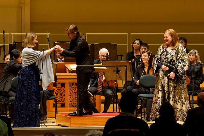 Daniela Candillari shakes hands with Giulia Semenzato on stage after the performance