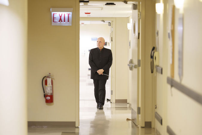Jaap van Zweden walks backstage in Orchestra Hall before the concert, stoic and poised